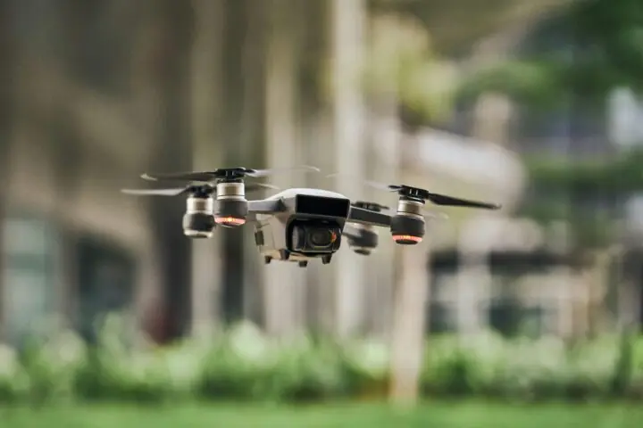 A drone floats above the ground.