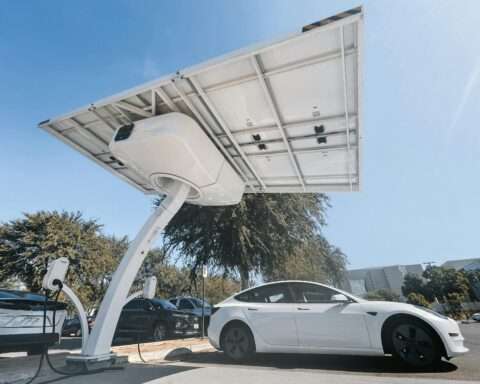 An EV charging station with a white car parked.