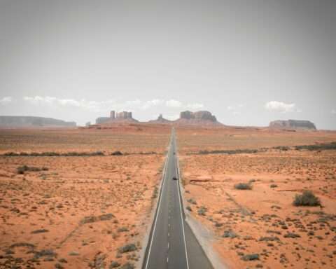 An Arizona highway juts to distant rock formations.