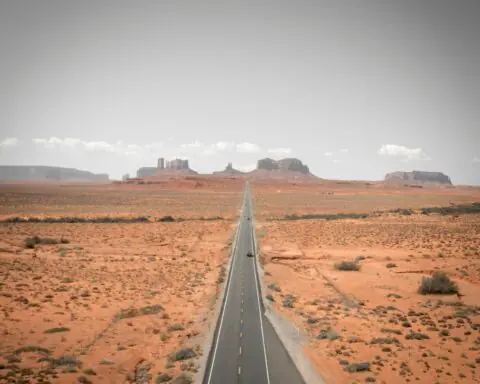 An Arizona highway juts to distant rock formations.