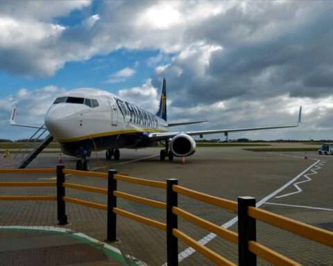 An airplane on the ground at a terminal.