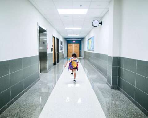 A child running through a school hallway.