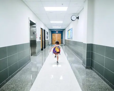 A child running through a school hallway.
