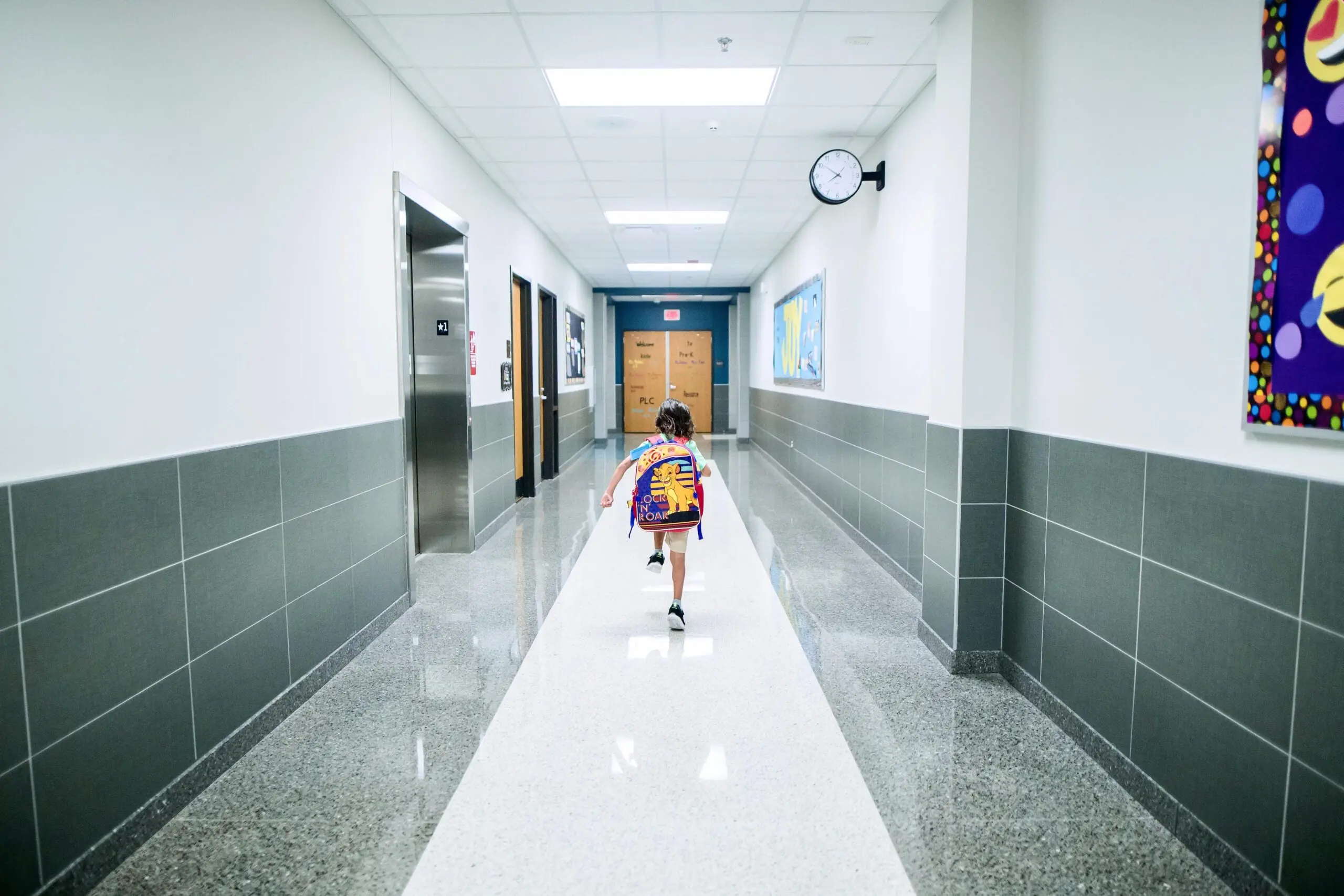 A child running through a school hallway.