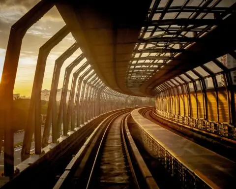 A rail corridor in a setting sun.
