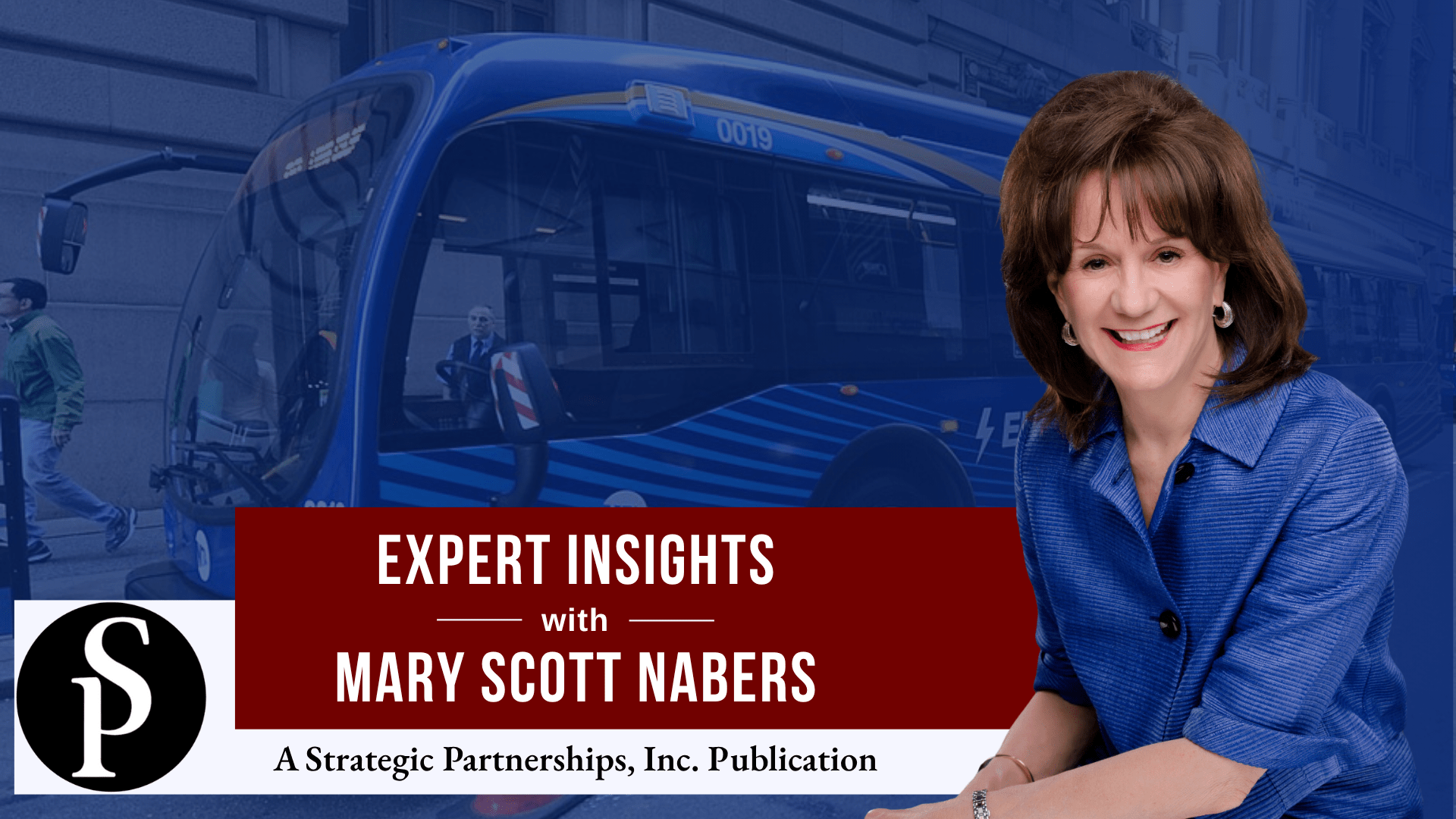 Mary Scott Nabers before an electric bus for her column about transit-oriented developments.