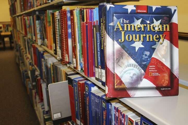 A row of textbooks in a college library.