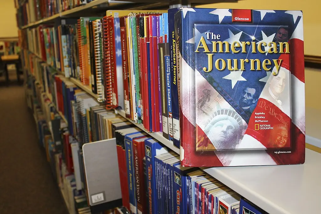 A row of textbooks in a college library.