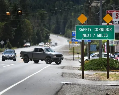 A Safety Corridor sign in Oregon before a turning truck.