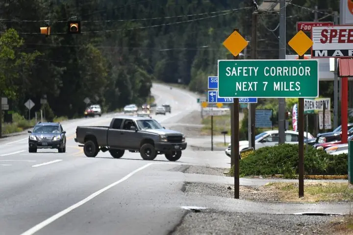 A Safety Corridor sign in Oregon before a turning truck.