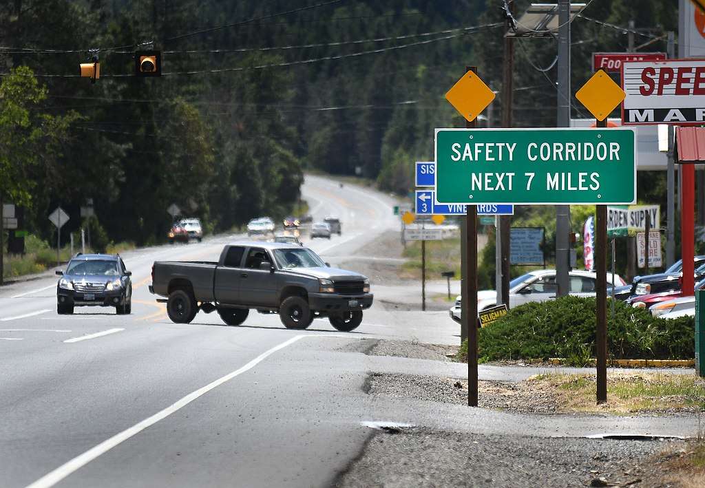A Safety Corridor sign in Oregon before a turning truck.