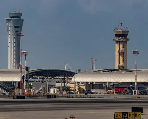 An air traffic control tower at an airport on a cloudy day.