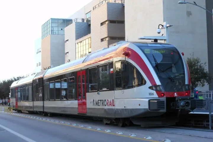 A CapMetro train on tracks in Austin.