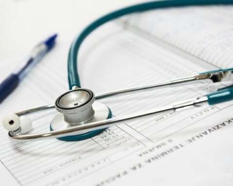 A stethoscope and a pen on a paper.