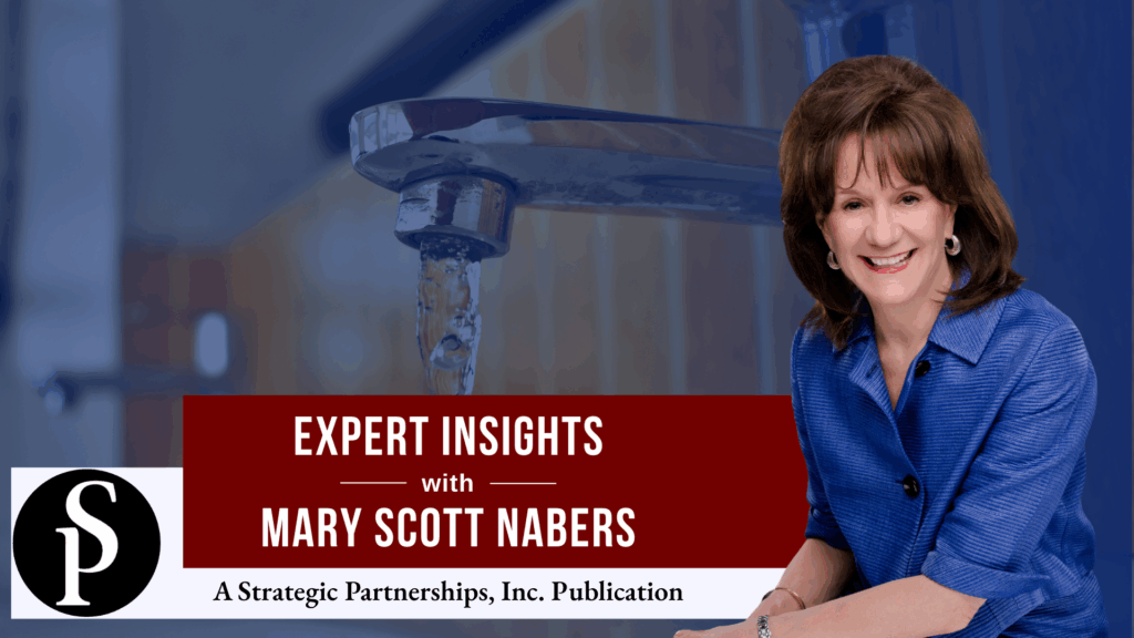 Mary Scott Nabers before a pouring faucet with water dripping out.