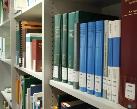A row of school books in a university library.