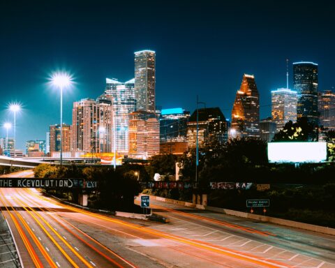 The Houston skyline from a highway at night.