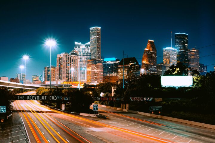 The Houston skyline from a highway at night.