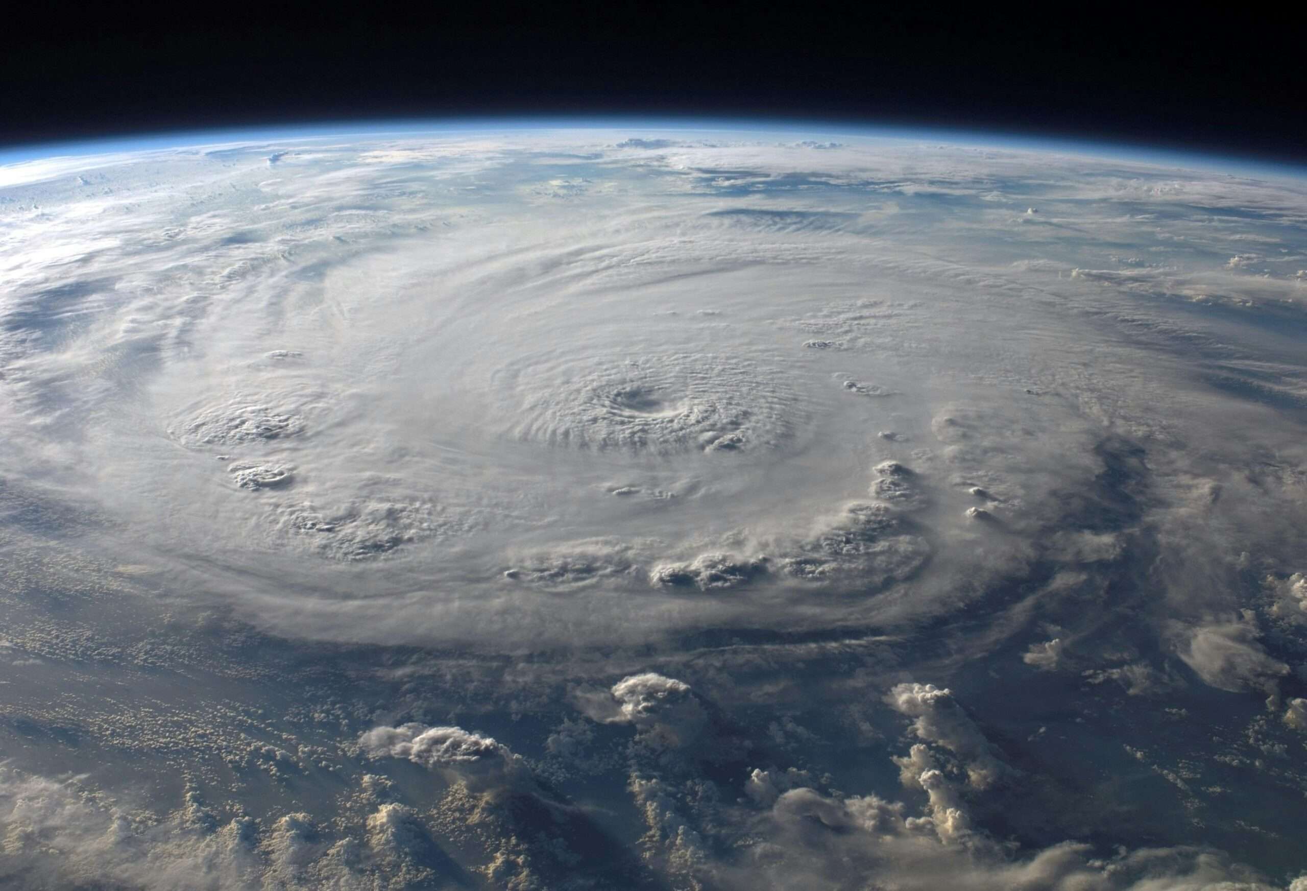 A satellite view of a hurricane striking land.
