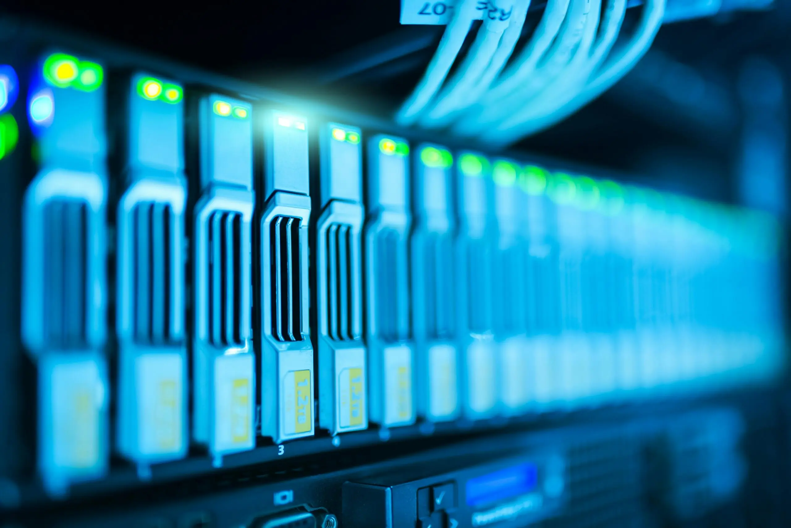 Several stacks as part of a server lit in blue light.