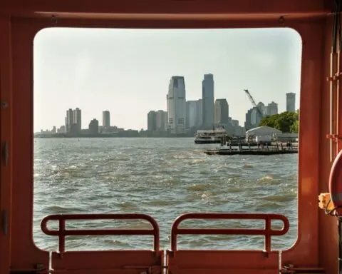 New York City from a port hole in a distant boat.
