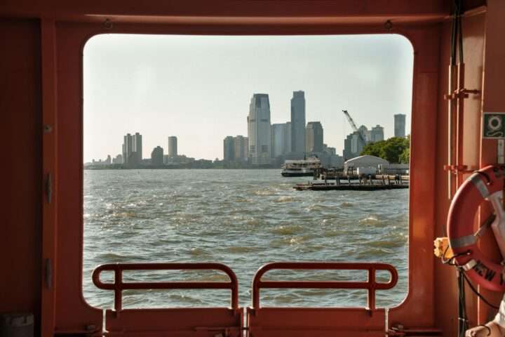New York City from a port hole in a distant boat.