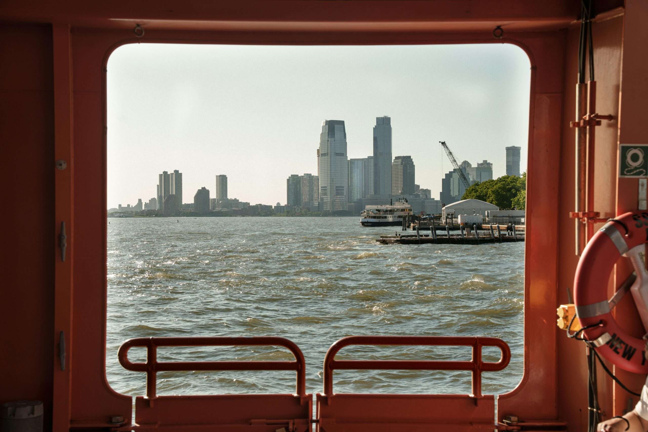 New York City from a port hole in a distant boat.