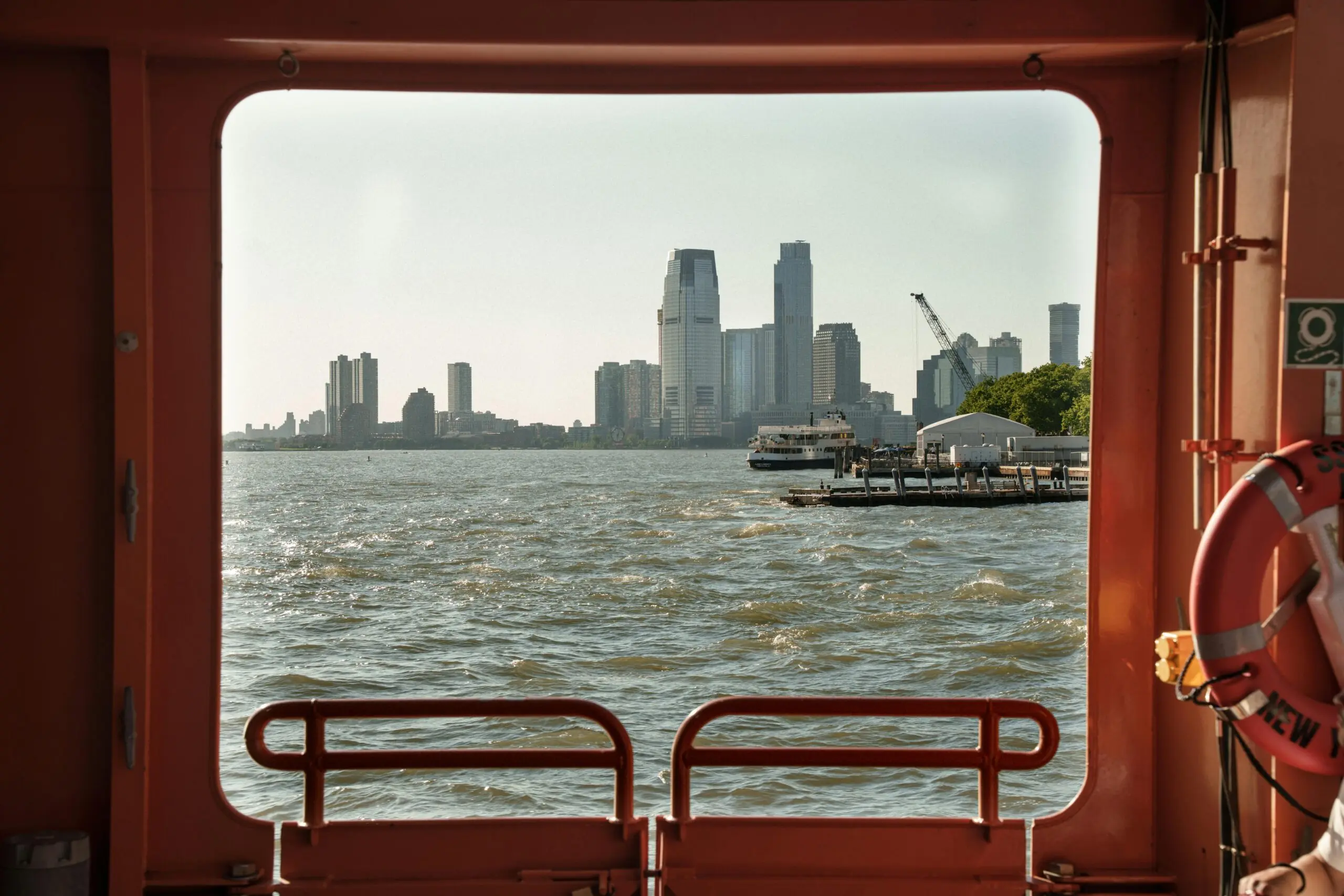 New York City from a port hole in a distant boat.