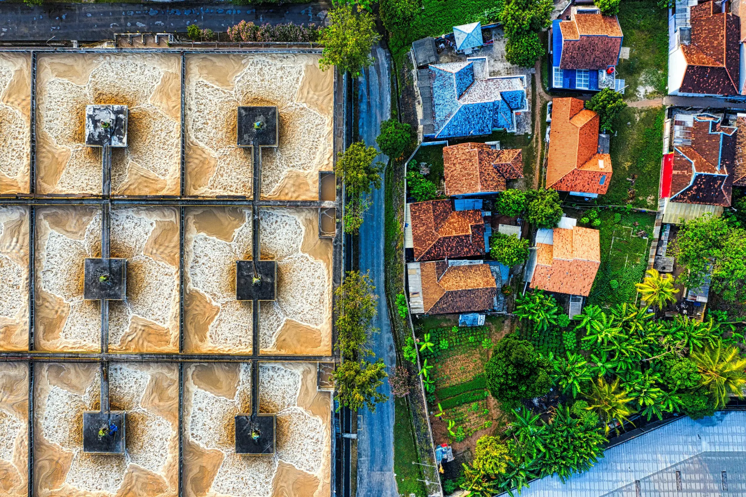 A top-down view of a municipal water treatment plant and some local houses.