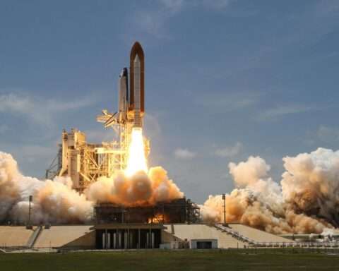 A rocket takes off from a platform.