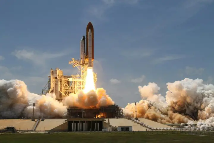 A rocket takes off from a platform.