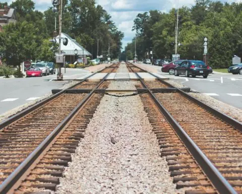 A rail crossing over a residential street.