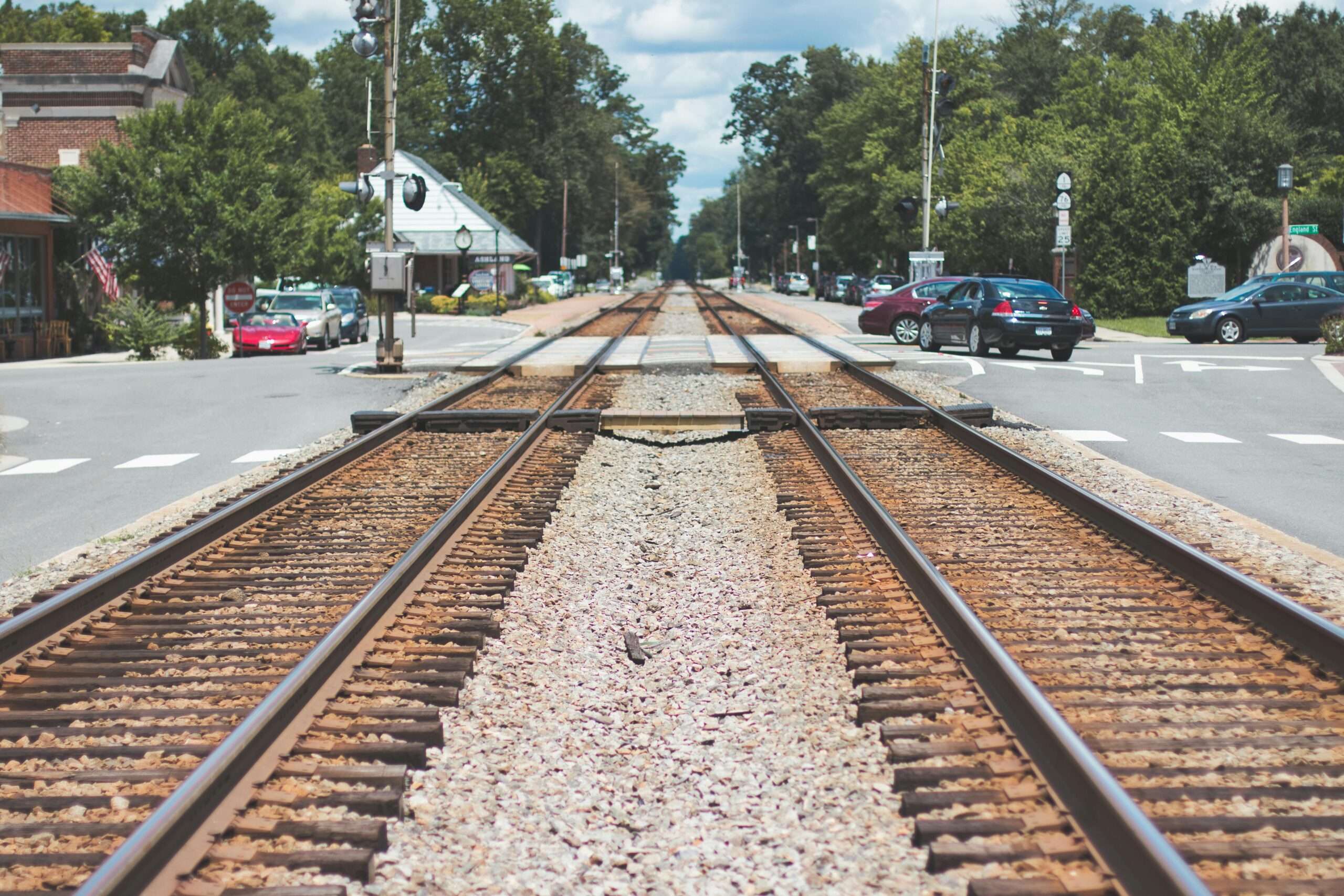 A rail crossing over a residential street.