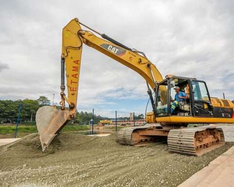 A yellow excavator on a job site.