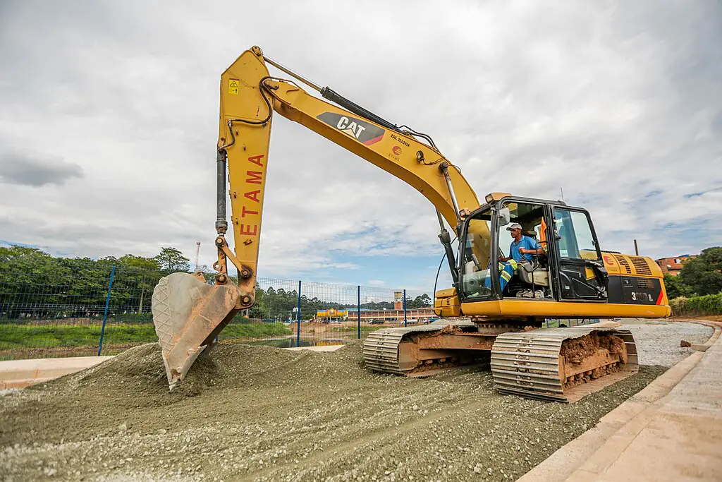 A yellow excavator on a job site.