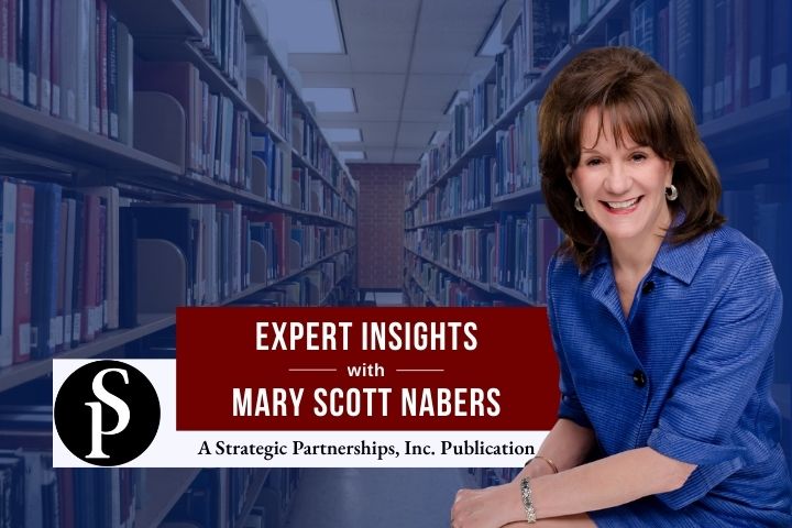 Mary Scott Nabers before an isle of books at a library for her weekly column.