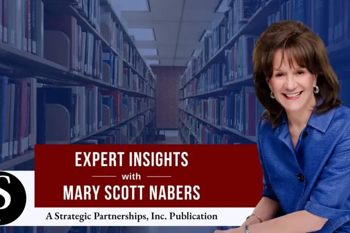 Mary Scott Nabers before an isle of books at a library for her weekly column.