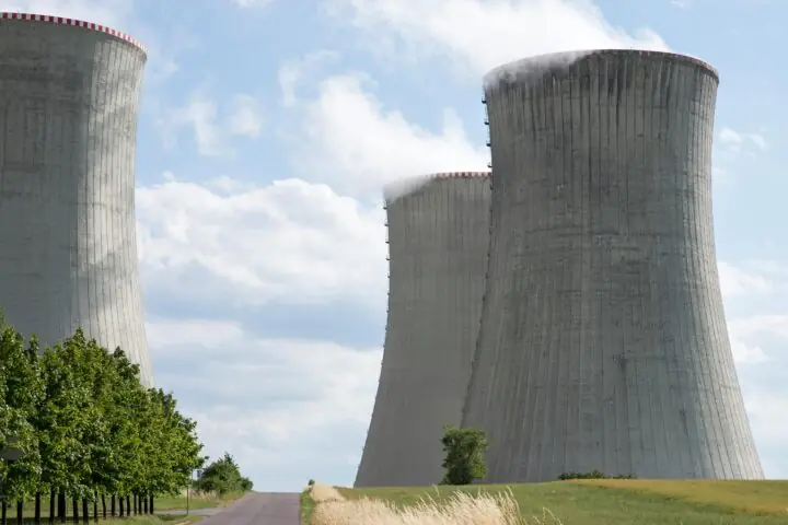Nuclear silos before a blue sky.