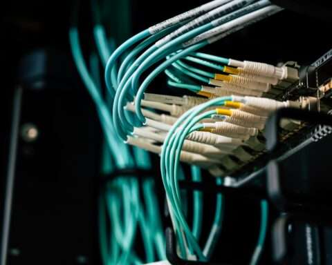 Blue ethernet cables connect to a broadband device.