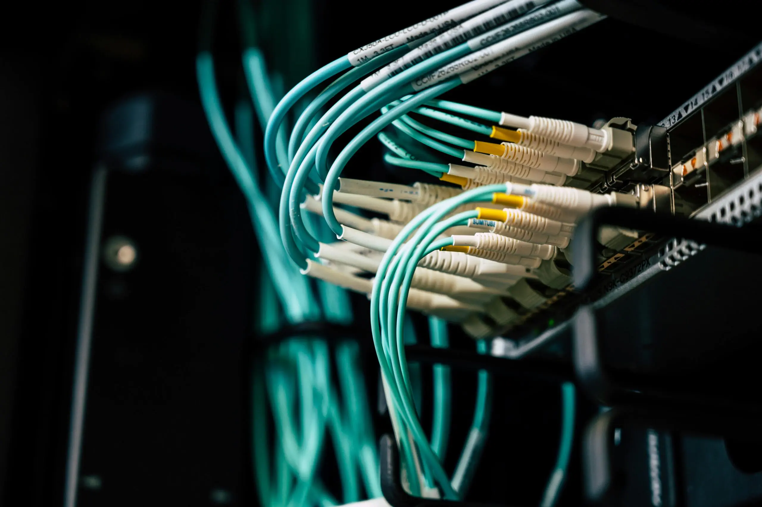 Blue ethernet cables connect to a broadband device.