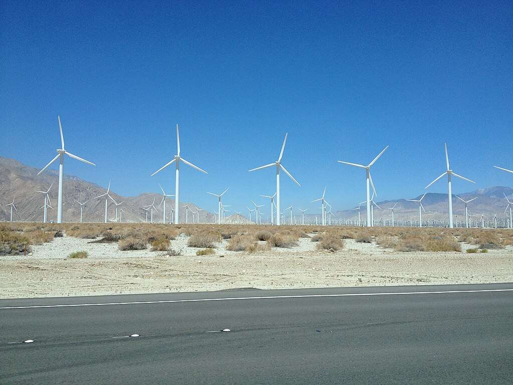 Wind energy mills before a blue sky.