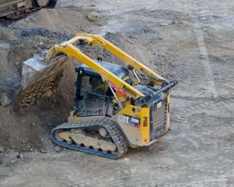 A small construction vehicle moving dirt.