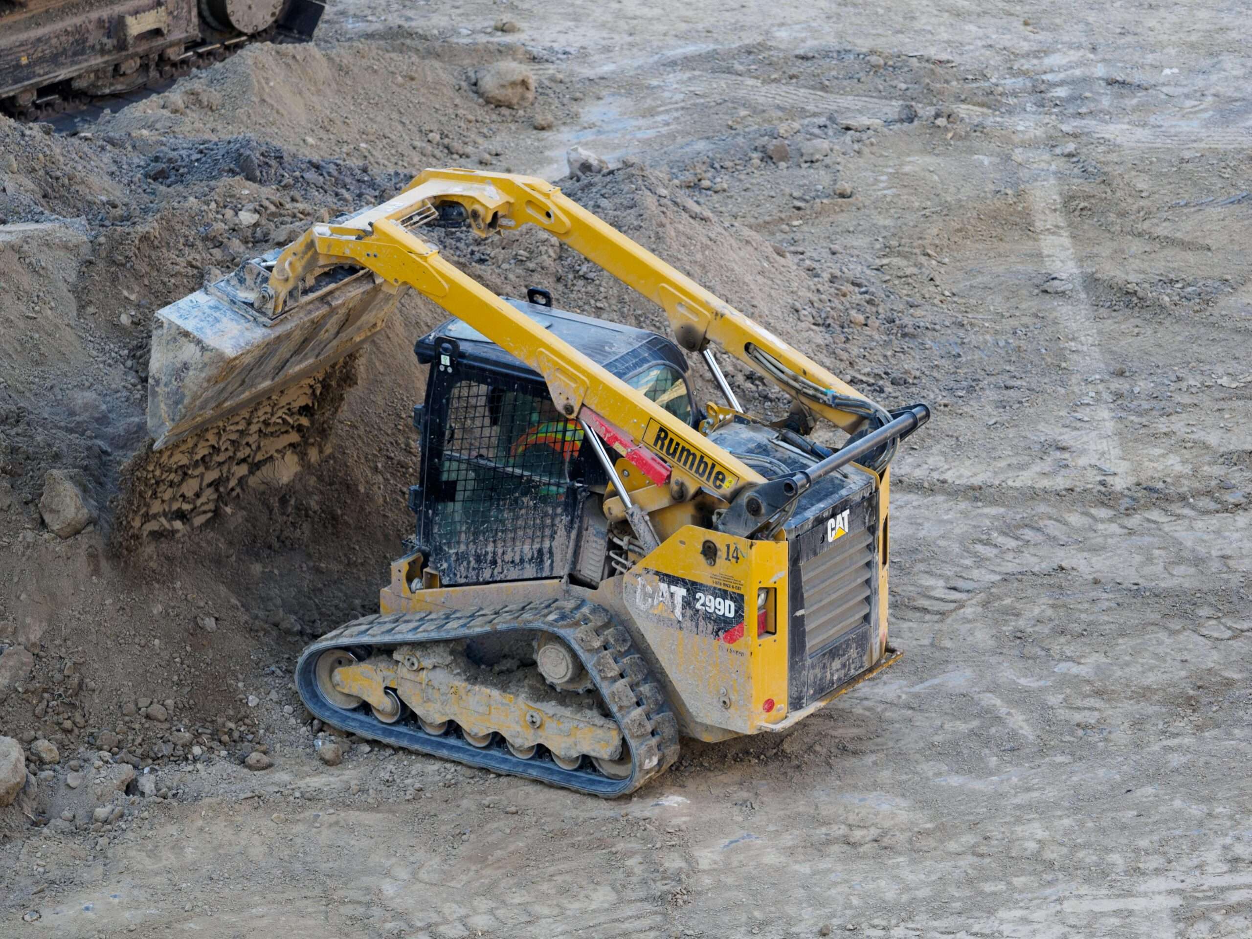 A small construction vehicle moving dirt.