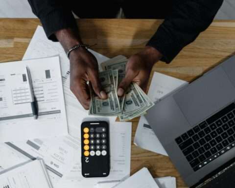 Money and office supplies on a desk.