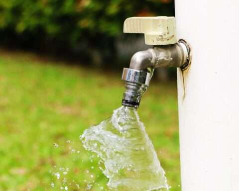 A water spout on the exterior of a house.