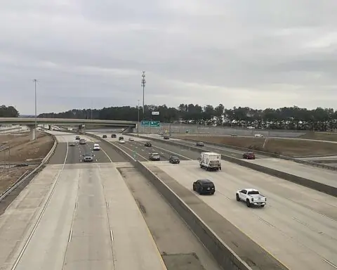 I-20 from above with cars in both directions on a cloudy day.