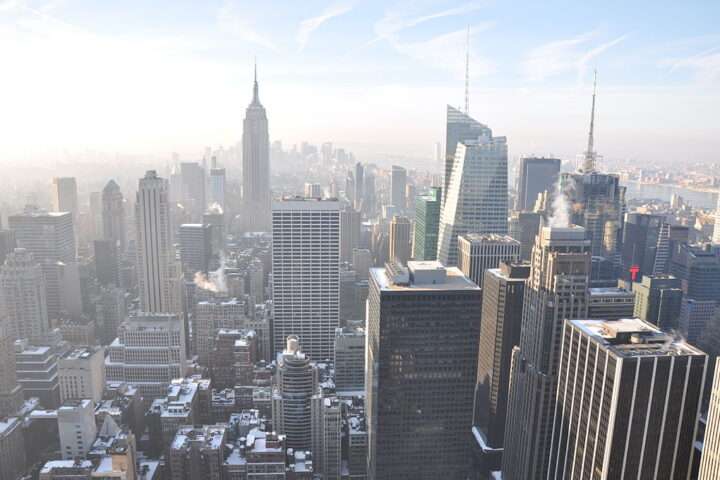 The New York City skyline form above on a sunny and hazy day.