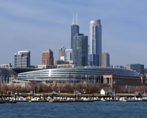Soldier Field in Chicago from across the river before the Chicago city skyline.