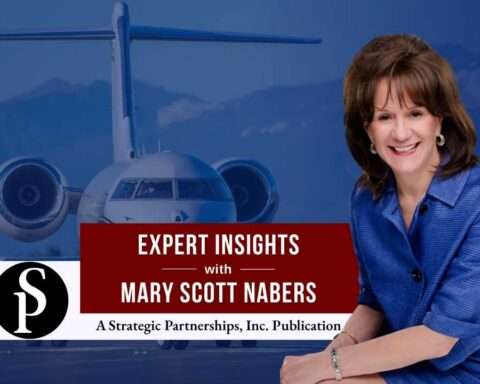 Mary Scott Nabers before a landed airplane for her weekly column.