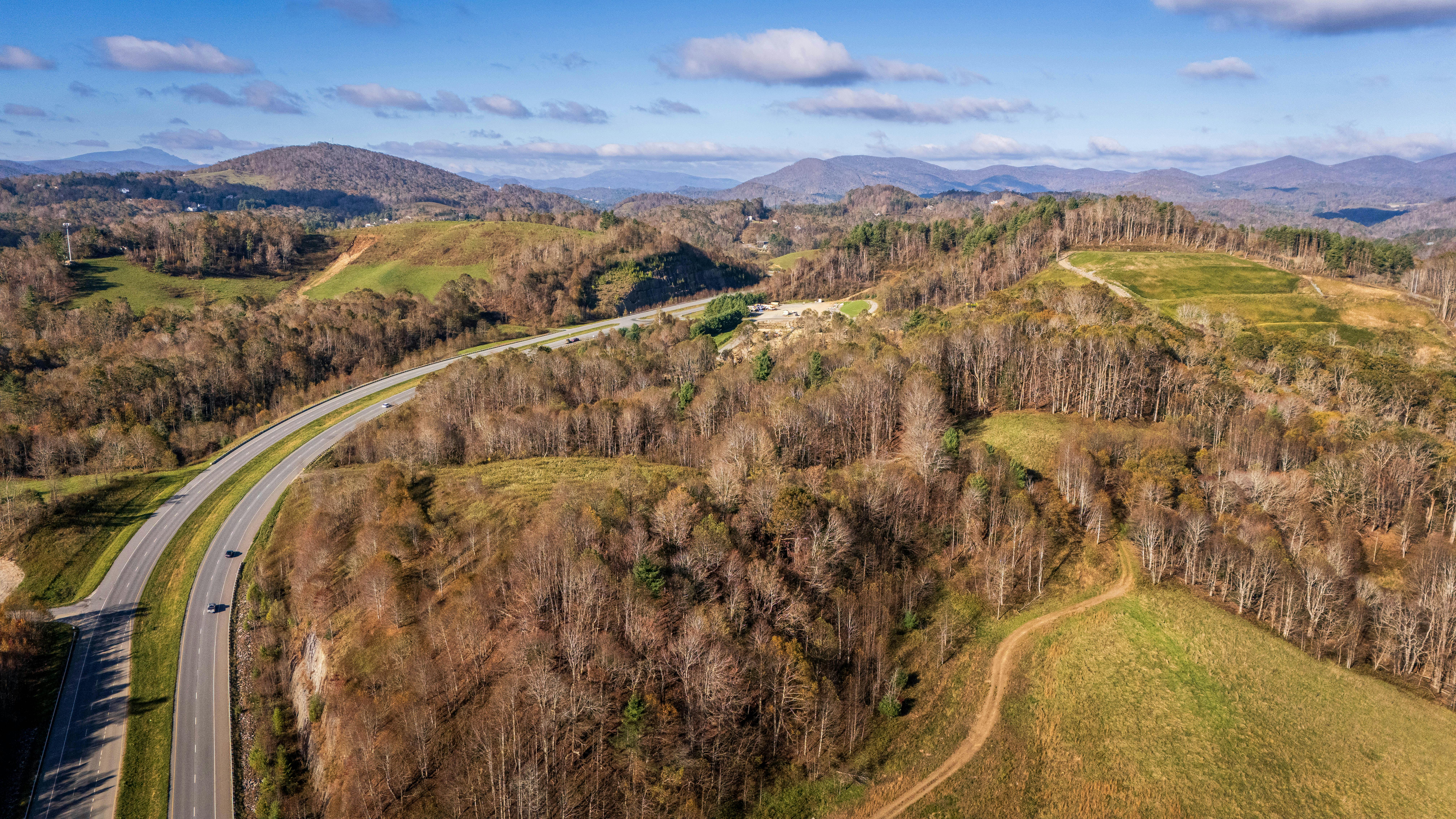 An aerial view of Boone North Carolina's forest nearby a highway.
